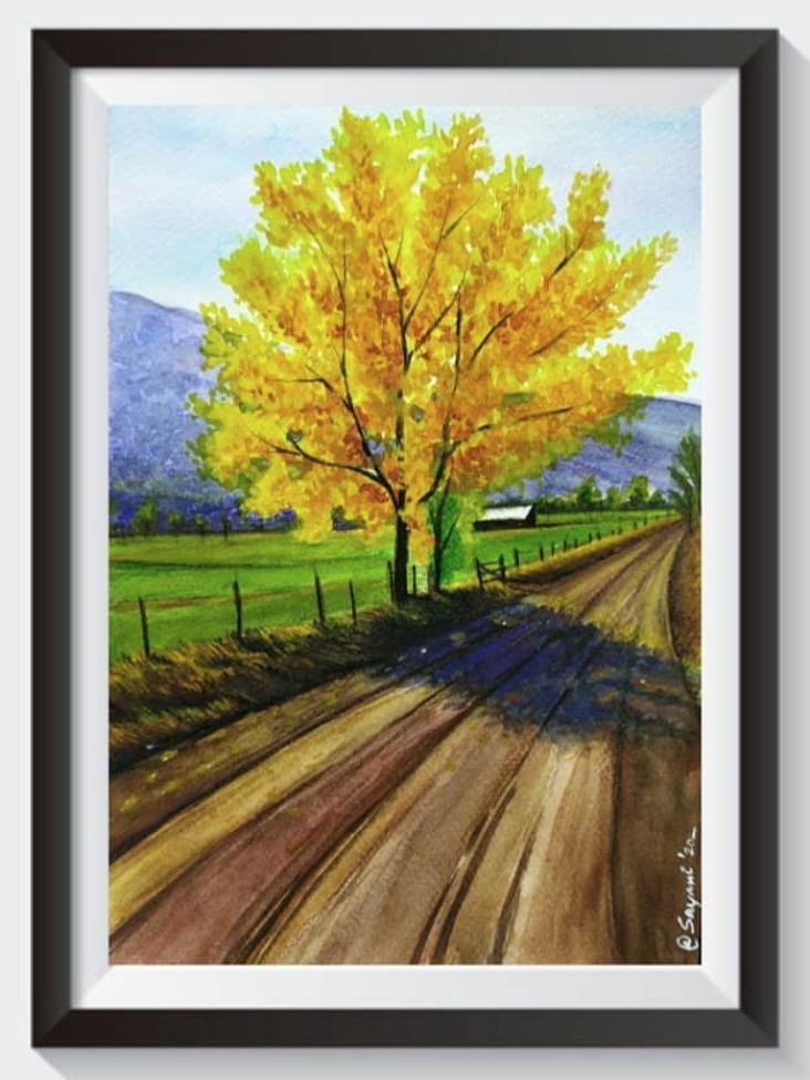 Framed watercolour painting of a golden autumn tree beside a country road